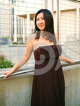 Happy Asian Girl Lean On Handtrail Outdoor