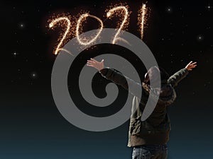 Happy Asian girl open arm with joyful on countdown night with firework light for 2021 year. image of happy new year celebration