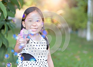 Happy asian girl play bubble soap at home