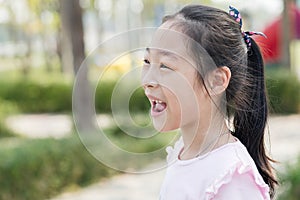 Happy Asian girl at playground outdoor.