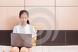 Happy asian girl using computer laptop notebook