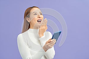 Happy asian girl using phone, celebrating success, online win, excited young woman reading good news, showing yes gesture