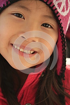 Happy Asian girl in wintry hat photo