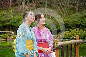 Happy asian girls sightseeing cherry blossom