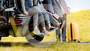 Happy asian group of friends with car travel driving and suitcase at mountain road