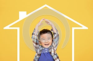 Happy asian kid making symbolic roof of hands above