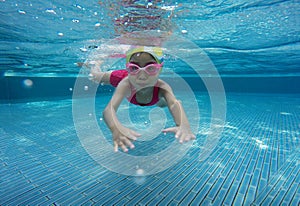 Happy asian kid swimming underwater in summer.