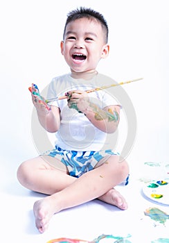 Happy asian little baby childhood playing use paintbrush draw watercolor