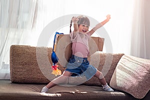 Happy Asian little child girl playing in an astronaut costume