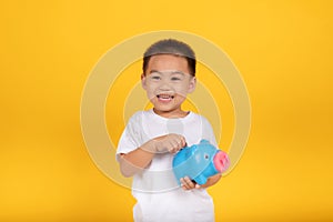 Happy Asian Little Children Boy saved a little money for future need wearing white T-shirt