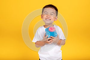 Happy Asian Little Children Boy saved a little money for future need wearing white T-shirt