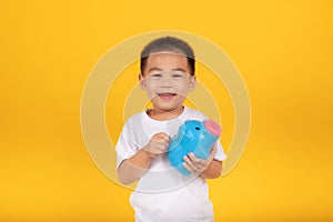 Happy Asian Little Children Boy saved a little money for future need wearing white T-shirt