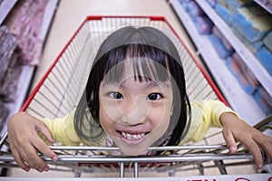 Happy Asian Little Chinese Girl sitting in shopping cart