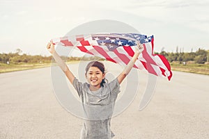 Happy asian little girl with American flag USA celebrate 4th of July