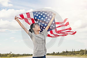 Happy asian little girl with American flag USA celebrate 4th of July