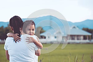 Happy asian little girl hugging her mother with love