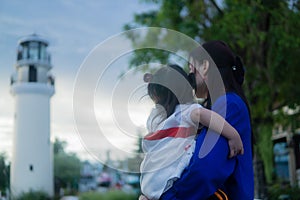 Happy Asian little girl and mother looking far away