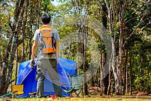 Happy Asian man backpack in park and forest background Relax time on holiday concept travel