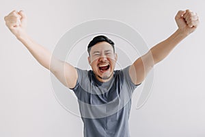 Happy asian man feels victory emotion stand isolated on white, Win and success