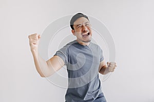 Happy asian man feels victory emotion stand isolated on white, Win and success