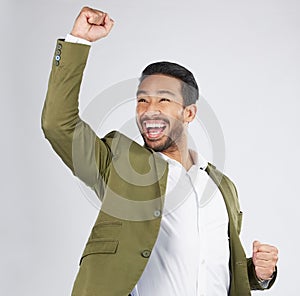 Happy asian man, fist pump and celebration in winning, success or promotion against a white studio background. Excited