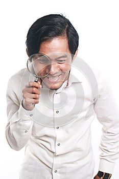Happy Asian Man With Magnifying Glass