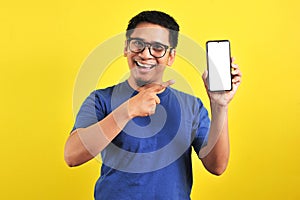 Happy Asian man showing a phone screen and pointing photo