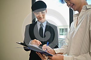 Happy asian man signing a rental agreement with real estate agent. Loan, property and insurance concept