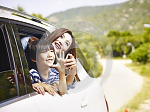 Happy asian mother and son on a sightseeing trip