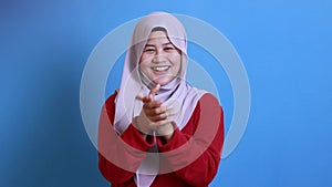 Happy Asian muslim woman wearing hijab, happy proud clapping gesture
