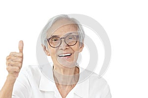 Happy asian old elderly wearing spectacles,raising hand sign,showing great thumbs up,smiling senior woman giving a thumbs up