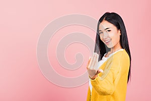 Happy Asian portrait beautiful cute young woman teen smile positive friendly making gesture hand inviting to come here with hand l