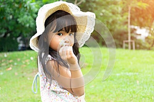 Happy Asian portrait little girl play with soap bubbles and sunlight summer in park outdoor