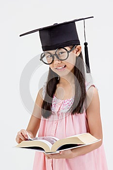 Happy Asian school kid graduate in graduation cap