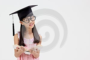 Happy Asian school kid graduate in graduation cap