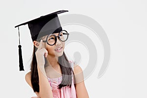 Happy Asian school kid graduate in graduation cap