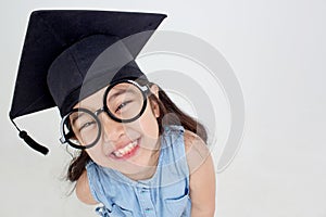 Happy Asian school kid graduate in graduation cap