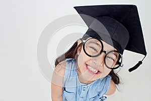 Happy Asian school kid graduate in graduation cap