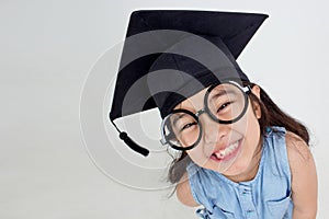 Happy Asian school kid graduate in graduation cap