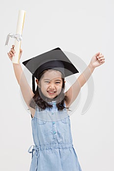 Happy Asian school kid graduate in graduation cap