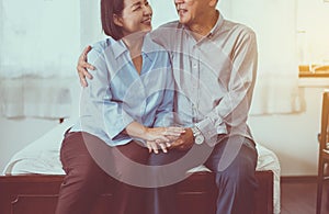 Happy asian senior couple encourage and hugging on bed together,Happy and smiling,Positive thinking