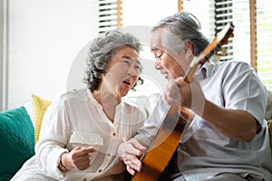 Happy Asian senior Couple enjoying photo