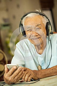 Happy asian senior man Headphones
