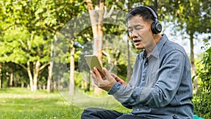 Happy asian senior man Headphones Listening Music