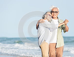 Happy Asian senior man and woman couple smile dancing resting relax on the beach