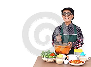 Happy Asian senior woman is cooking,