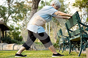 Happy asian senior woman exercising by stretching the leg muscles,female elderly has lost so much weight,excellent healthy,strong