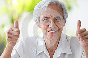 Happy asian senior woman give thumb raised up,feel fit and healthy,Smiling old elderly showing two thumbs up gesture at her good