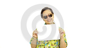 Happy Asian senior woman with hawaii green shirt holding white b