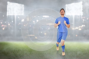 Happy asian soccer player celebrate his goals